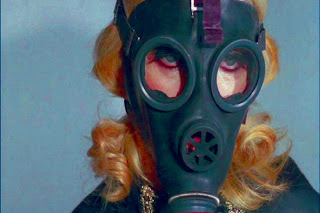 Pamela Stanford wearing a gas mask in Jess Franco's "Blue Rita".